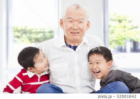 happy grandfather and grandchildren playing  32001642