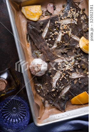 Baking tray with flounder and seasoning on the 32002581