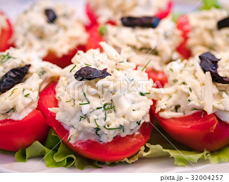 Stuffed tomatoes with cheese and garlic. Stuffed tomatoes with cheese and garlic. 32004257