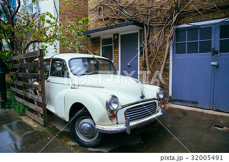 Retro car parked in old European city street Retro car parked in old European city street 32005491