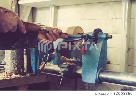 Man using old wood lathe turning wood Man using old wood lathe turning wood 32005866