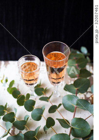 eucalyptus branches on an old table with a glass 32007461