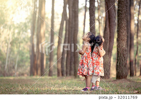 two asian girls hug their chest and turn back 32011769