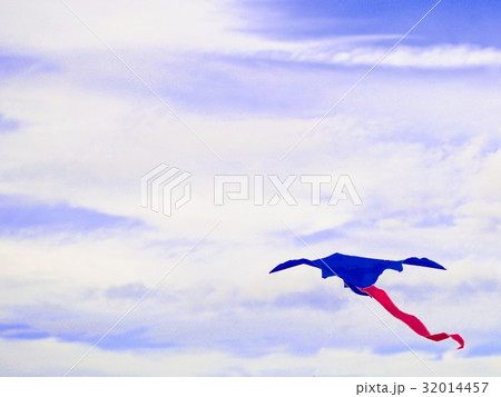 Kite blue with a red tail isolated on blurred sky. Kite blue with a red tail isolated on blurred sky. 32014457