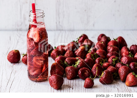 detox water in bottle with strawberry on white detox water in bottle with strawberry on white 32016991