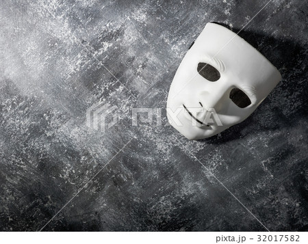 White mask on gray grunge background. White mask on gray grunge background. 32017582