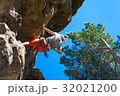 Young girl rock climber climbing mountain rock  32021200
