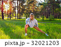 Stretching blonde girl in outdoor exercise. 32021203
