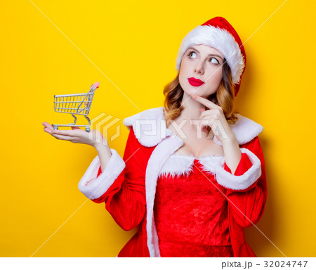 Santa Clous girl in red clothes with shopping cart 32024747