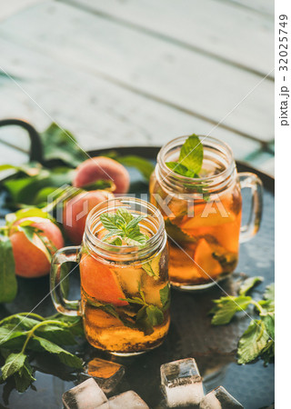 Summer refreshing cold peach ice tea on table 32025749