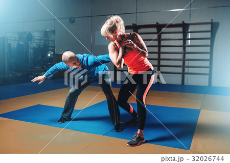 Woman in actoin on self-defense training 32026744