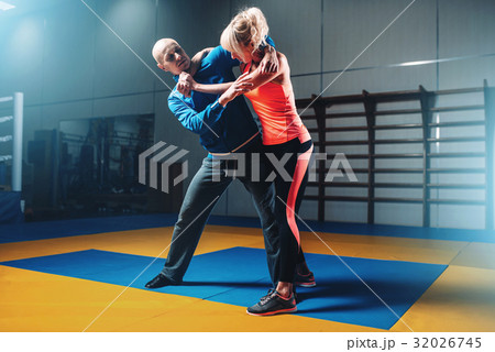 Woman fights with man on self-defense training 32026745