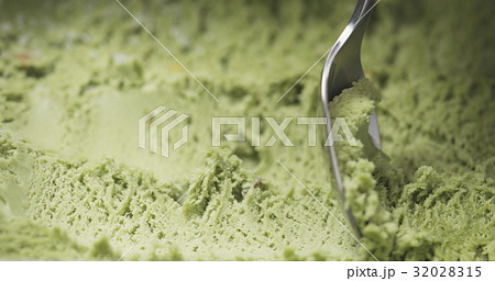 macro of pistachio ice cream being scooped with macro of pistachio ice cream being scooped with 32028315