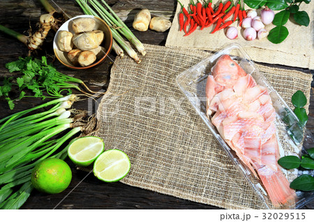 Preparing cooking Thai spicy sour soup with fish. 32029515