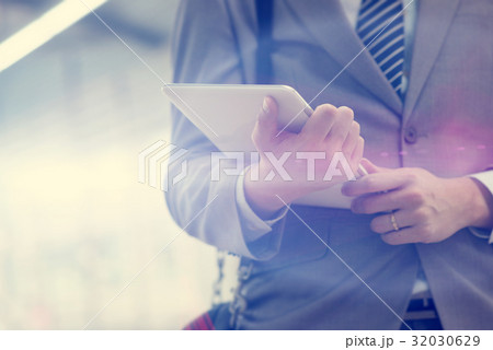 Business people and tablet pc, train station. 32030629
