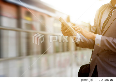 Business people and tablet pc, railway station. Business people and tablet pc, railway station. 32030630