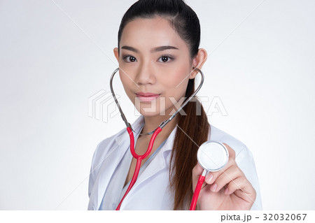 female doctor showing stethoscope for checkup over white background. physician or medical practitioner holding stethoscope to auscultate breath in medical visit 32032067
