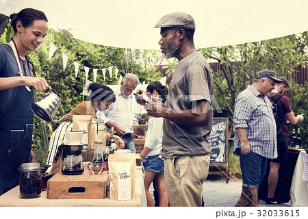 Man Selling Coffee Fresh Brew to People at Market Man Selling Coffee Fresh Brew to People at Market 32033615