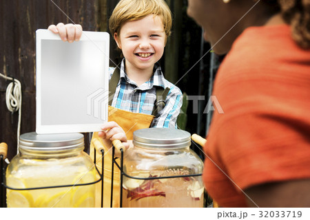 Boy selling lemonade juice at healthy product fair 32033719