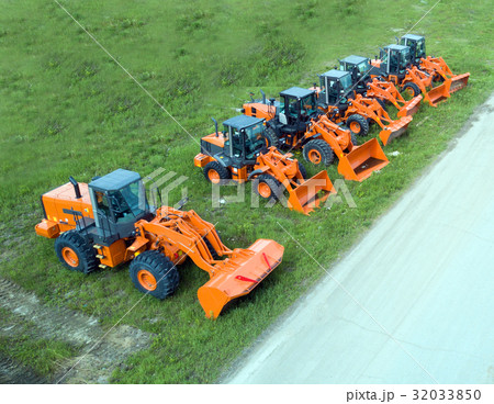 New, shiny and modern orange excavator machines. 32033850