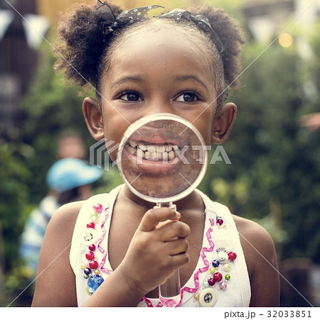 Kid is using magnifier studying 32033851