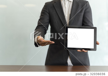 Businessman using his tablet in the office 32036036