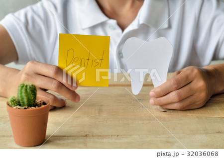 woman hold paper cuts tooth shape, dental concept woman hold paper cuts tooth shape, dental concept 32036068