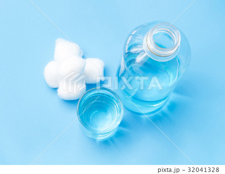 Glass bottle of blue alcohol and cotton wools Glass bottle of blue alcohol and cotton wools 32041328