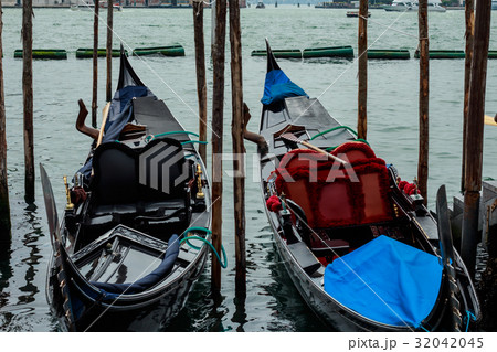 Black and white gondola boats mooring in the sea 32042045