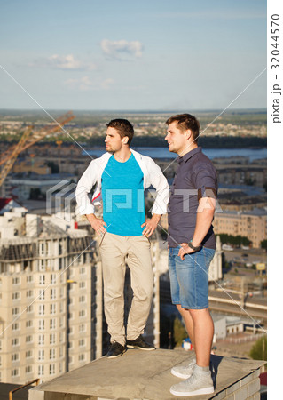 Two roofers on housetop Two roofers on housetop 32044570