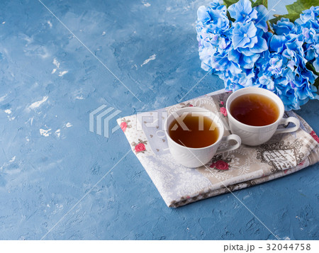 Cup of tea on blue background with flowers Cup of tea on blue background with flowers 32044758