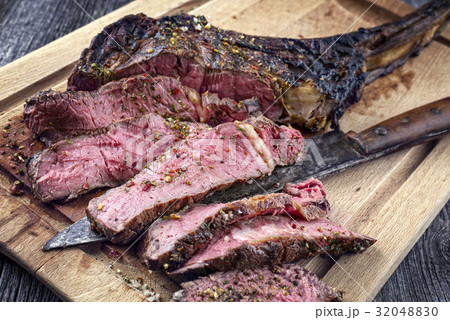 Barbecue Tomahawk Steak on Cutting Board 32048830