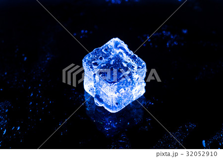 Blue ice cubes on black wet table. Blue ice cubes on black wet table. 32052910