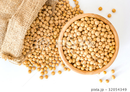 Soybeans in a wooden bowl on a white background. 32054349
