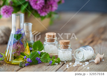 Vials of tincture, bottles of homeopathy globules. 32057038