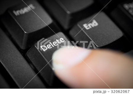 Pointing finger pressing on delete button 32062067