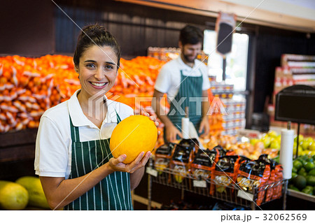 Female staff holding vegetable in supermarket 32062569