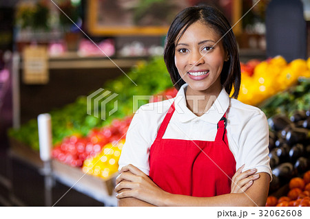 Smiling female staff standing with arms crossed in organic section Smiling female staff standing with arms crossed in organic section 32062608