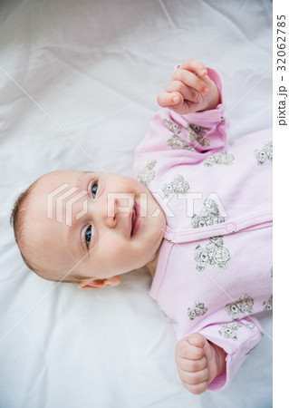 Cute baby boy relaxing on bed 32062785