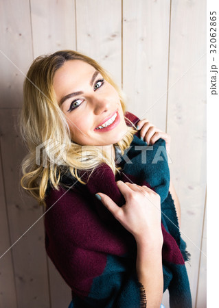 Portrait of smiling woman posing against texture background Portrait of smiling woman posing against texture background 32062865