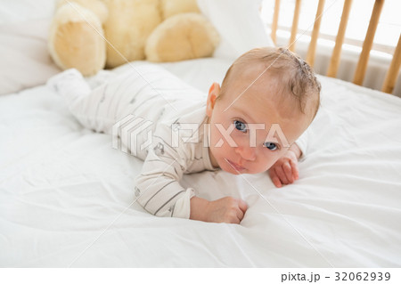 Baby lying on baby bed Baby lying on baby bed 32062939