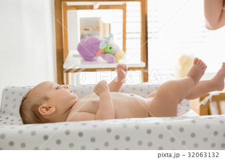 Baby lying on baby bed Baby lying on baby bed 32063132