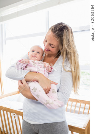 Mother holding her baby boy Mother holding her baby boy 32063264