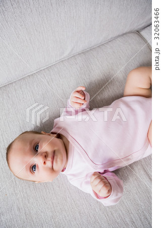 Baby lying on sofa in living room Baby lying on sofa in living room 32063466