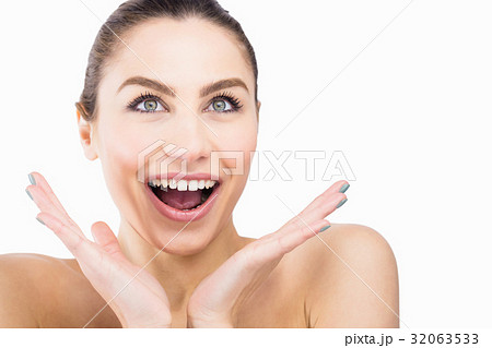 Beautiful woman posing with shocked expression against white background 32063533