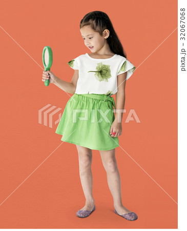 A girl is holding green magnifier A girl is holding green magnifier 32067068