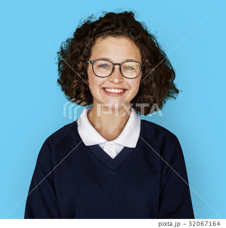 Portrait studio shoot of schoolgirl in uniform with smiling 32067164