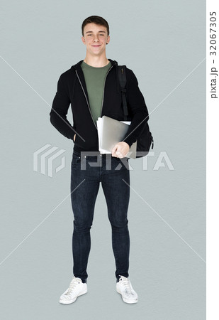 Young adult man smiling and holding laptop Young adult man smiling and holding laptop 32067305