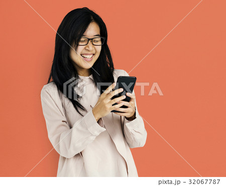 Young adult asian girl smiling and using mobile phone 32067787