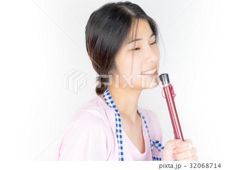 Happy Asian housewife is singing with broom stick Happy Asian housewife is singing with broom stick 32068714
